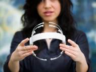 Tan Le, the Co-Founder/President at Emotiv Systems, holds Emotiv EPOC