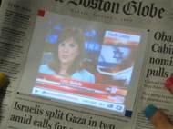 An usage of SixthSense, watching aditional media while reading the newspapers.
