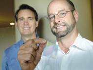 Joe Bagan, CEO of Sharklet Technologies (right), and Mark Spiecker, vice president, show off a sample of their shark-skin film